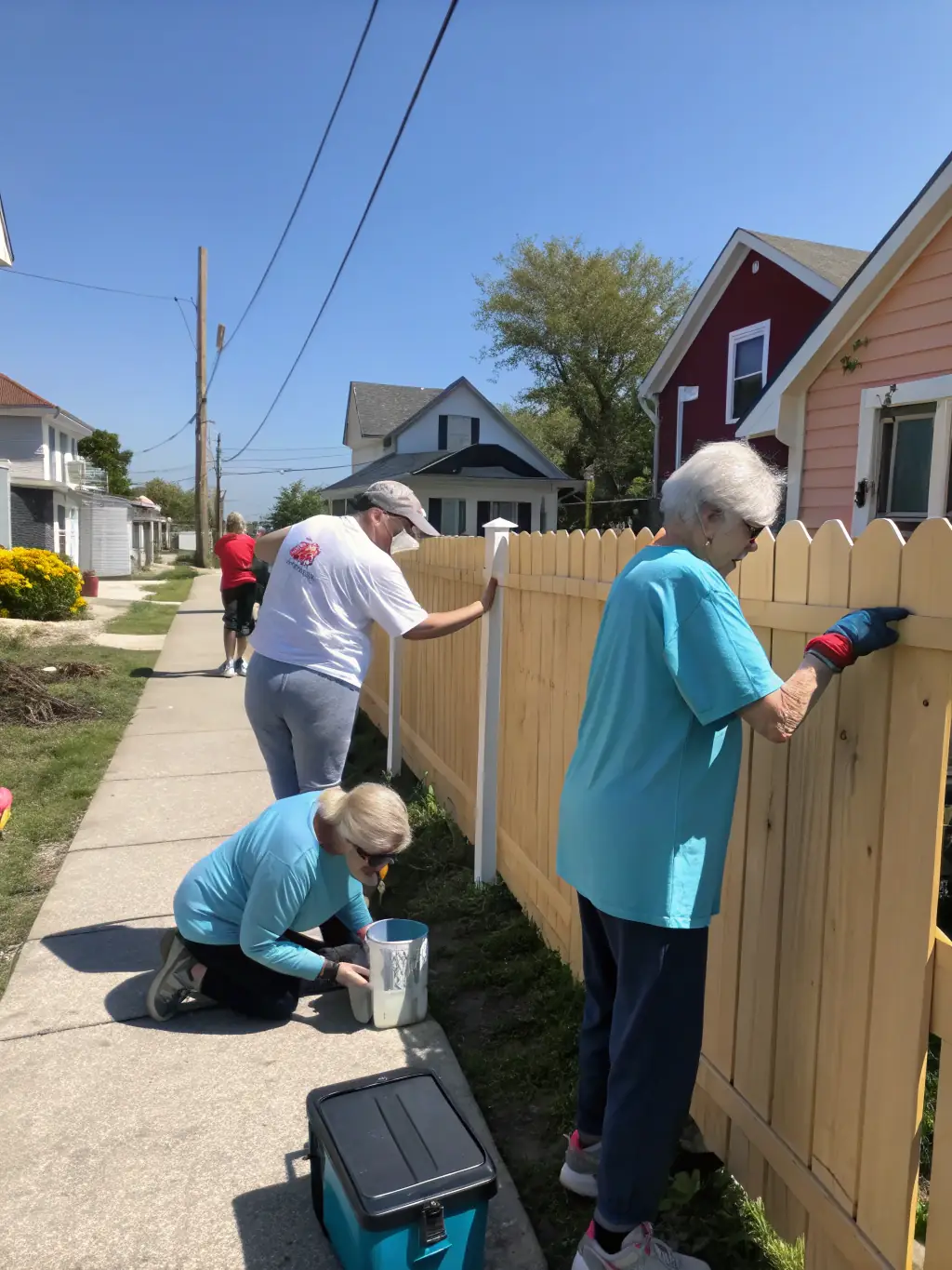 A photo of volunteers assisting elderly residents with home maintenance tasks, demonstrating the organization's dedication to supporting vulnerable members of the community and improving their living conditions.